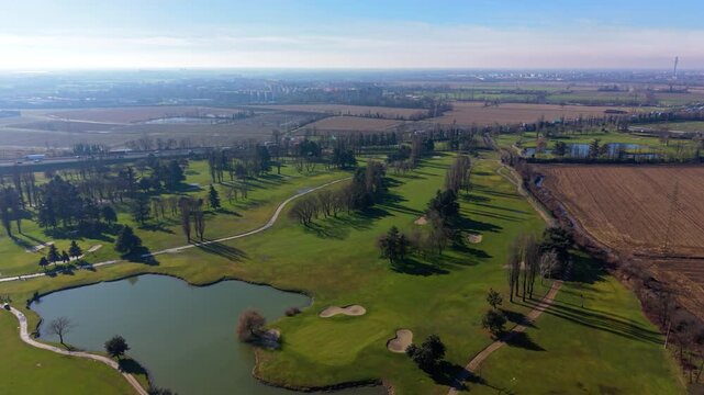 Aerial view flying over green golf course