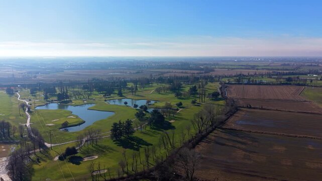 Aerial view of a golf course surrounded by countryside