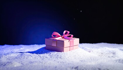 Gift With Ribbon in Snow Against Dark Background, For Holiday or Special Occasion