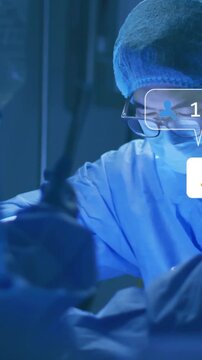 Vertical video: Surgeon operating in OR tools moving after pullback icons rising showing engagement