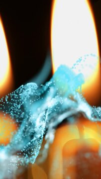 Vertical video: Frame shifting, turquoise particles wrapping right candle flame, showing wick glow