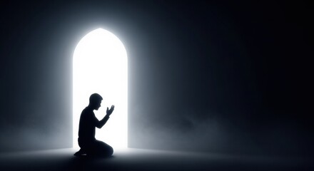 Obraz premium Minimalist Silhouette of Person Praying Within a Bright Glowing Doorway in a Dark Room