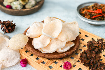 Fototapeta premium Kerupuk, Indonesian flour chips or crackers, deep-fried and served on a clay plate. They're typically enjoyed with sambal (chili sauce) as a condiment.