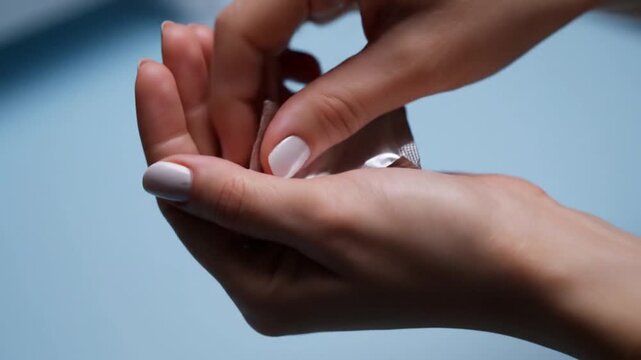 Close up condom wrapper opened on palm video sequence.