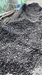 Rough Black Gravel Pile in Industrial Yard