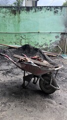 Rusted Wheelbarrow Full of Debris in Construction Site