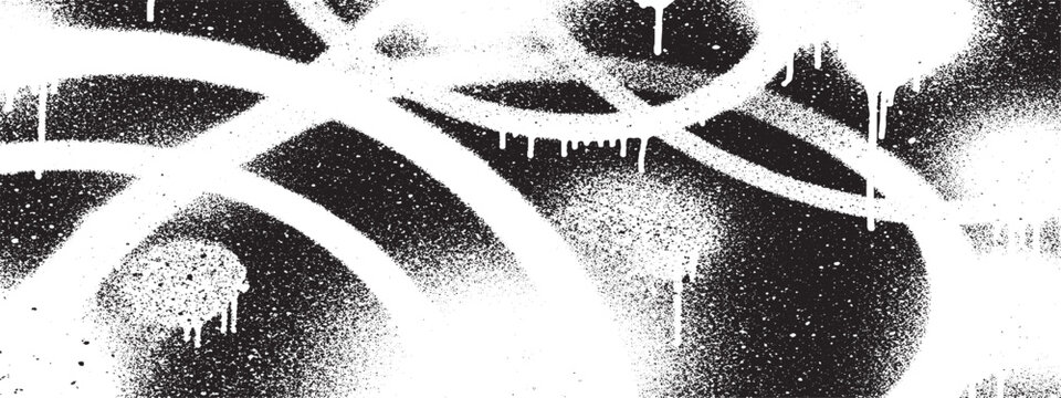 Abstract white graffiti spray paint drips on black background.