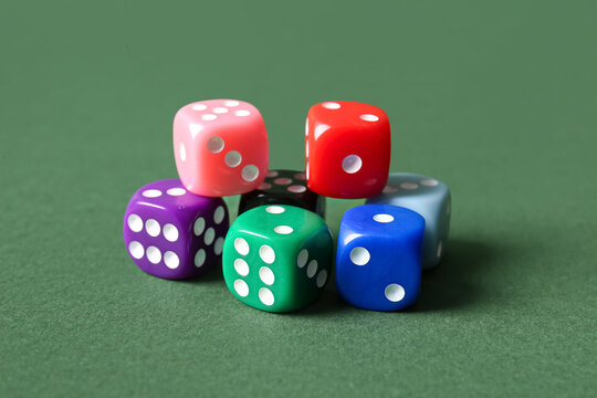 Colorful game dices on green background