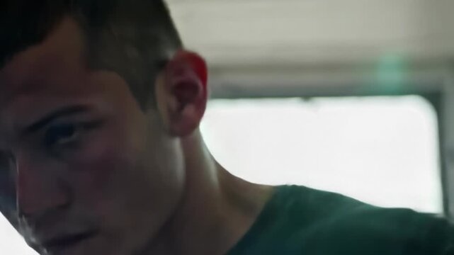 Focused face during shadow boxing, camera moving laterally with punches, motion trails subtle, dramatic lighting, high intensity workout realism.