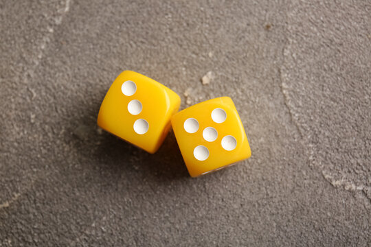 Yellow dices on grey background