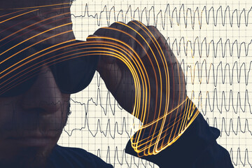 Worried adult male face over damaged electrocardiogram showing cardiac distress