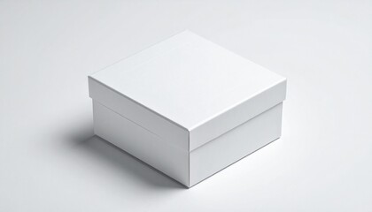 Fototapeta premium A simple, clean white square gift box with a lid on a light background, casting a soft shadow.