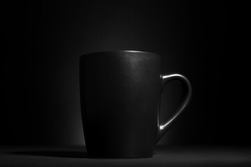 Obraz premium Black cup on dark background, closeup