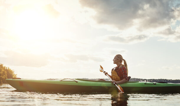 Kayak, space and woman on lake with rowing, recreation hobby and summer exploration on vacation. Flare, boat or person on river with canoe, holiday adventure and water sports in New Zealand.
