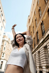 Young woman stretching in a london street fashion shoot