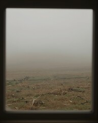 View Through Window Framed By Foggy Landscape With Earthy Tones and Soft Colors
