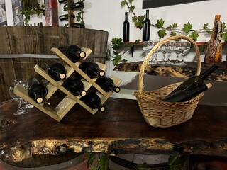 Traditional winery tasting area with handcrafted furniture and vintage decor. The scene shows an authentic wine storage room with barrels and shelves in a rural farm style.