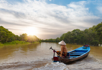 Fisherman is fishing in Mekong river in the morning -  Flooded trees in mangrove rain forest. Kampong Phluk village - Cambodia