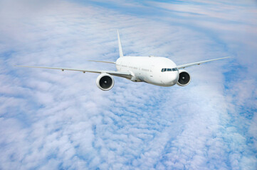 White passenger airplane flying in the sky amazing clouds in the background - Travel by air transport