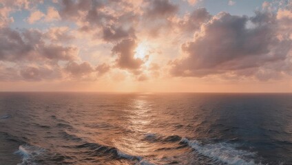 Fototapeta premium Ocean sunset with clouds and sun reflection on water.