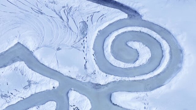 Outdoor public park in Winter time after deep snow fall from freezing cold front in central New York State village of Fairport