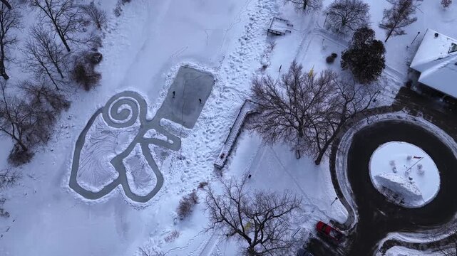 Outdoor public park in Winter time after deep snow fall from freezing cold front in central New York State village of Fairport