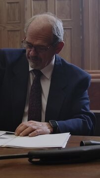 Criminal Trial lawyer in court pointing to notes - modern court room scene
