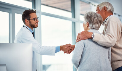 Handshake, clinic and doctor with senior couple for support, thank you or consulting in office....