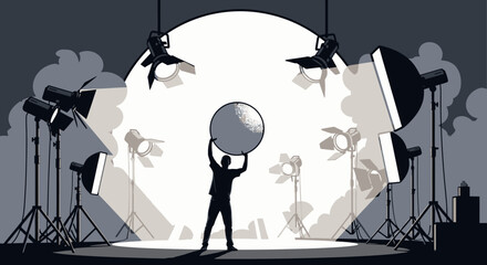 A person stands in the center of a stage, holding a large sphere under a bright spotlight surrounded by multiple studio lights. © Kiki