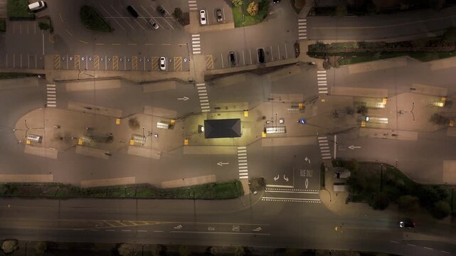 High Static Aerial Top Down View of Langley's Carvolth Exchange Bus Terminal at Night with Cars Driving on the Road