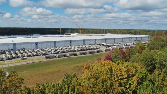 Wide aerial view of Colossus II xAI data facility with mobile generators parked nearby during autumn