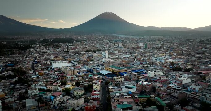 Sunrise drone flight over Arequipa city in Peru with Misti volcano in distance