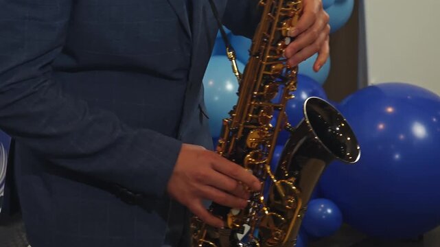 A detailed close-up video shot of a saxophone player's fingers rapidly moving over the instrument's buttons, highlighting the precision of playing.