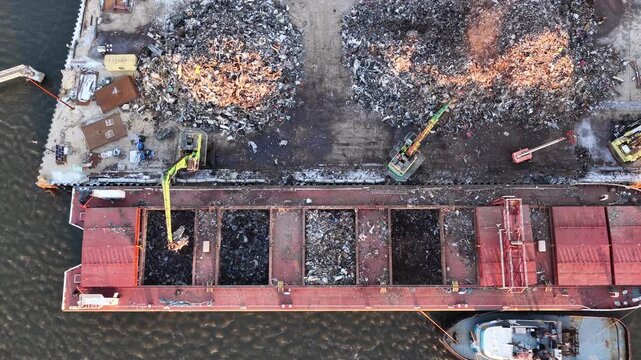 Metal Recycling Plant Loading Scrap Metal Onto a Barge in the Delaware River