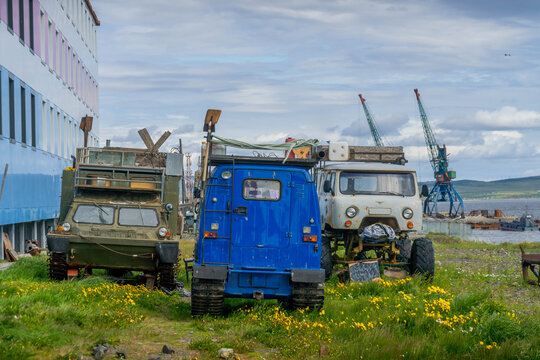 UAZ and 4WD vehicles including cargo trucks, snowmud rover and rugged ATV essential for Chukotka rugged tundra near Tavayvaam port, Arctic Russia.
