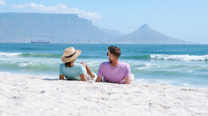 Relaxing couple enjoying beach day at Bloubergstrand in Cape Town, South Africa © Fokke Baarssen
