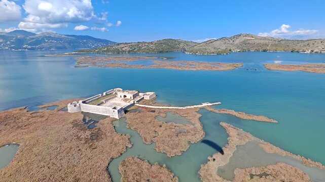 Ali Pasha Castle located on small island near Butrint in Albania captured from aerial perspective showing historical fortress and coastal scenery
