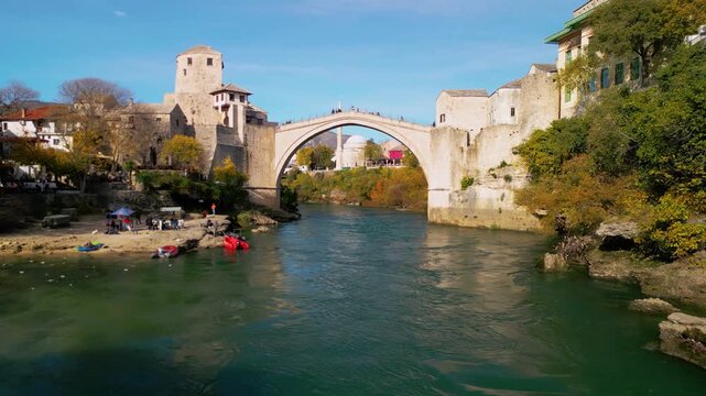 Epic 4K aerial panorama of Mostar Old Town and Stari Most bridge, UNESCO heritage site over turquoise Neretva river, Bosnia and Herzegovina, cinematic cityscape