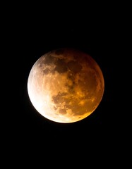 Illuminated celestial body showing phases, surrounded by night sky