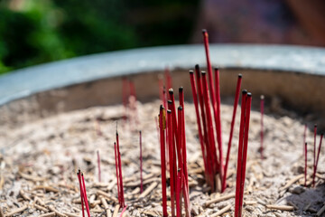 Peaceful incense scene. Serene display of burning incense during prayer. Tranquil moment with aromatic smoke among sacred artifacts during worship