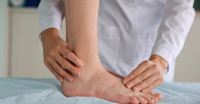 Doctor examines patient ankle for potential injury