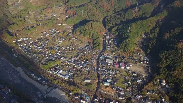 Flyover sunny mountain village of Nagiso on Nakasendo Trail in Japan