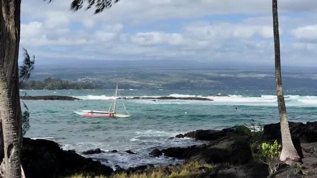 Serene Hawaiian coast with boat and waves, showcasing Hilo's calm beauty