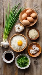 Fototapeta premium A colorful arrangement of ingredients including eggs, rice, green onions, garlic, chicken, and soy sauce on wooden surfaces, ready for cooking.