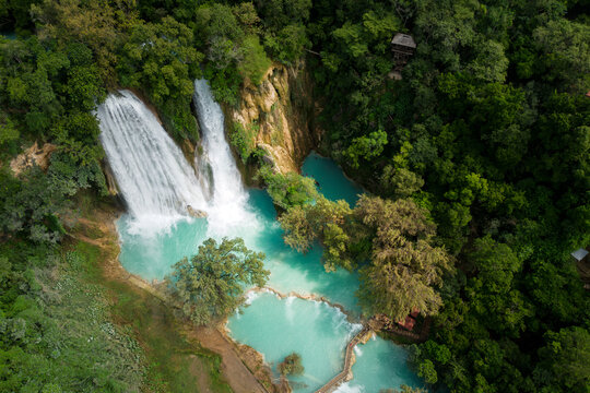 Cascada de Minas Viejas shows turquoise water surrounded by green trees in San Luis Potosi, Mexico with a view of the waterfalls and natural pools
