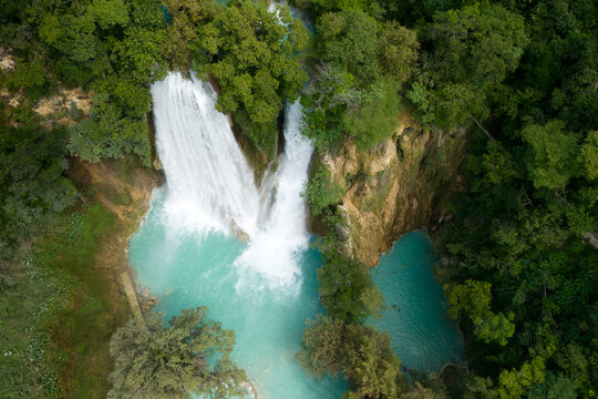 Visit Cascada de Minas Viejas in Huasteca Potosina, a turquoise waterfall surrounded by tropical plants in San Luis Potosi, Mexico
