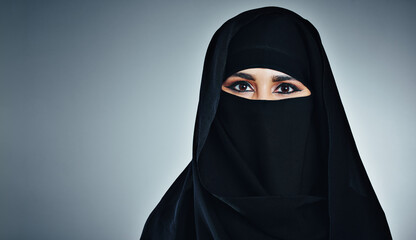 Naklejka premium Muslim, portrait or woman in studio with space, praise or religious practice during Ramadan. Mockup, spirituality or Arabic person on gray background with faith, Islam tradition or connection on Eid.