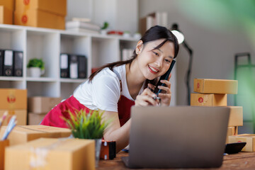 Asian woman small businesses SME owners asian female entrepreneurs call phone on receipt box and...