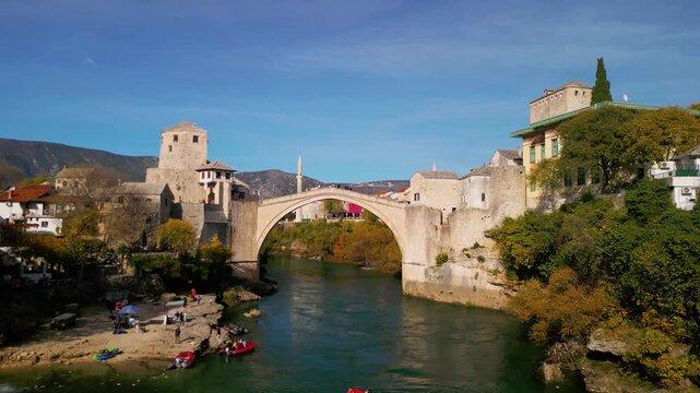 Epic historic bridge aerial reveal. 
Cinematic 4K drone pedestal up 
and tilt down over Stari Most 
in Mostar, Bosnia and Herzegovina.
