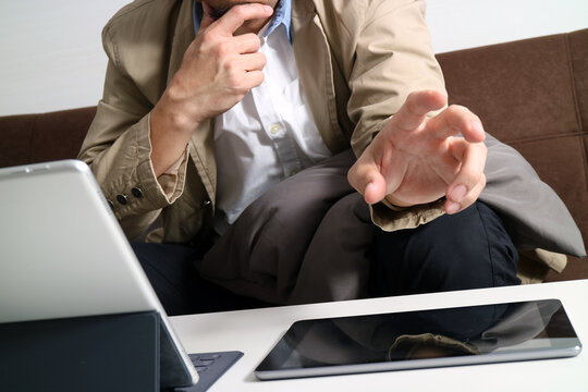 Man Thinking and Pointing at Tablet During Online Meeting at Home